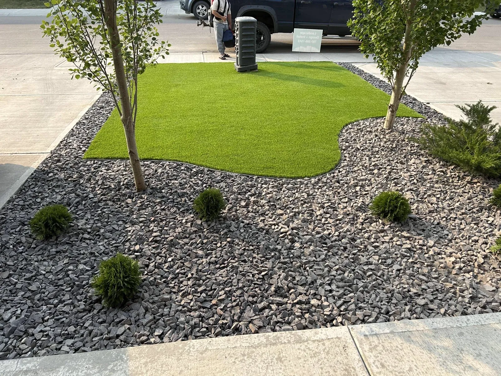 Artificial turf with a decorative rock bed, Edmonton front yard